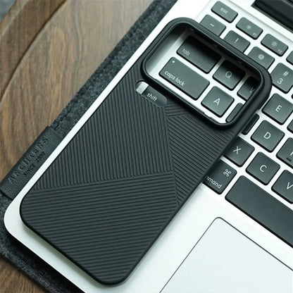Black phone case with textured design on a laptop